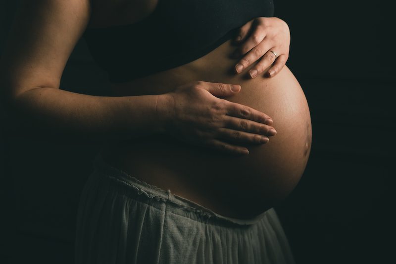 pregnant woman on the black background 2022 10 26 05 14 20 utc Mama Thrive